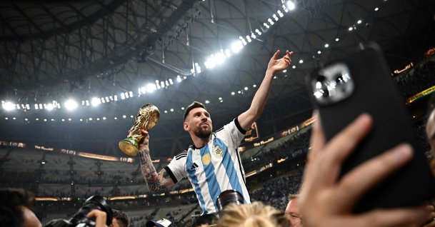 Argentina's captain and forward #10 Lionel Messi (R) holds the FIFA World Cup Trophy following the trophy ceremony after Argentina won the Qatar 2022 World Cup final against France at Lusail Stadium in Lusail, Doha, Qatar, Dec. 18, 2022. (AFP Photo)
