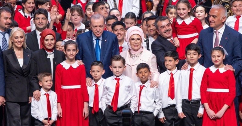 President Recep Tayyip Erdoğan and first lady Emine Erdoğan pose with the Presidential Children's Orchestra and Choir after a concert to mark April 23 Children's Day at the Presidential Complex in Ankara, Türkiye, April 22, 2026. (Photo Courtesy of the Turkish Presidency)