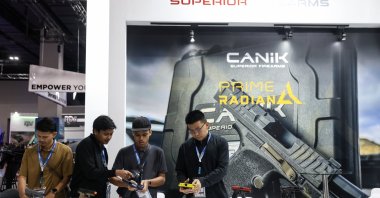 Visitors inspect firearms made by Turkish defense manufacturer Canik at the Defence Services Asia (DSA) and NATSEC Asia 2026 exhibition, Kuala Lumpur, Malaysia, April 21, 2026. (EPA Photo)