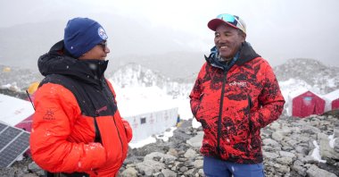 Kami Rita Sherpa (R), 55, smiles as he speaks with a friend at Everest Base Camp as he prepares to climb Everest for the 32nd time to break his own record, Everest region, Nepal, April 29, 2026. (Reuters Photo)
