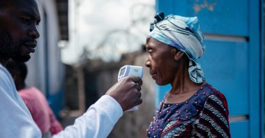 Hospital staff checks a visitor’s temperature using a contactless infrared thermometer, in Goma, DR Congo, May 17, 2026. (AFP Photo)
