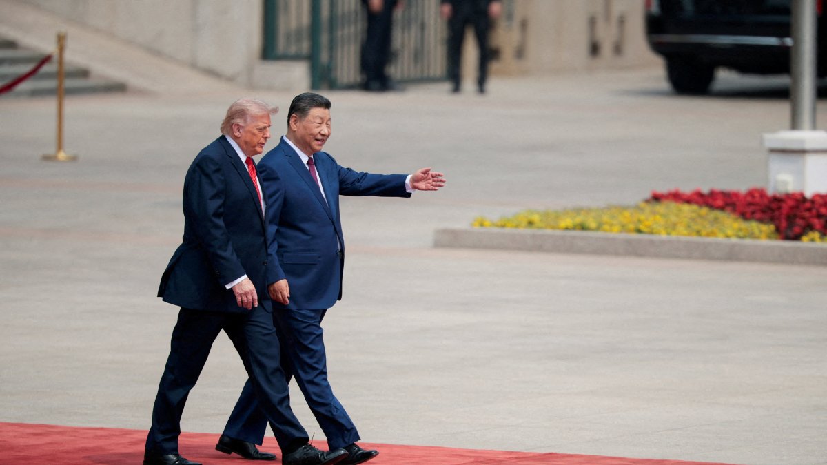 U.S. President Donald Trump walks with Chinese President Xi Jinping upon arrival at the Great Hall of the People in Beijing, China, May 14, 2026. (Reuters Photo)