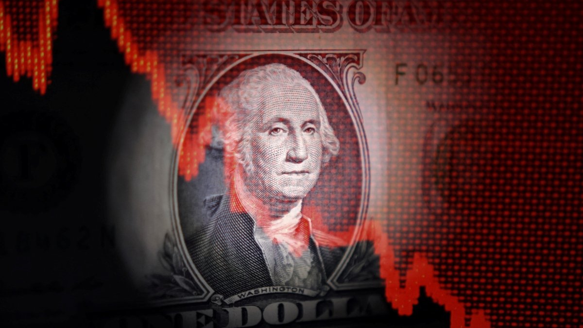 U.S. dollar banknote and decreasing stock graph are seen in this illustration taken April 25, 2025. (Reuters Photo)