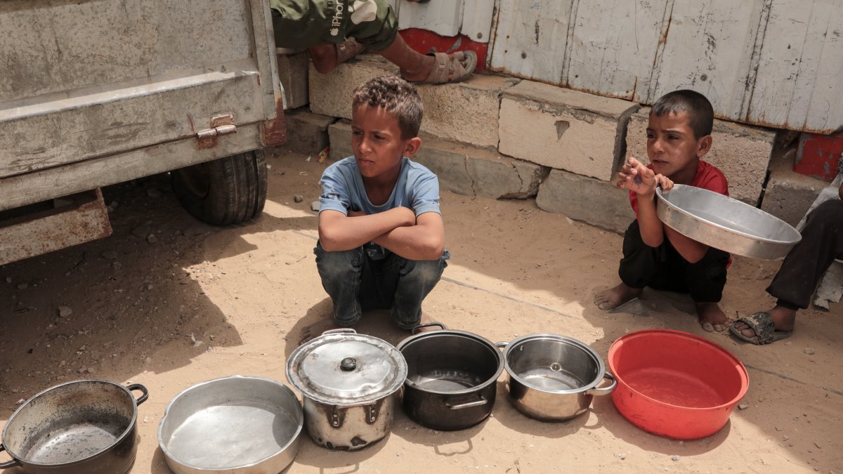 Palestinian children in camps wait in line for food aid, Gaza City, Palestine, May 18, 2026. (AA Photo)