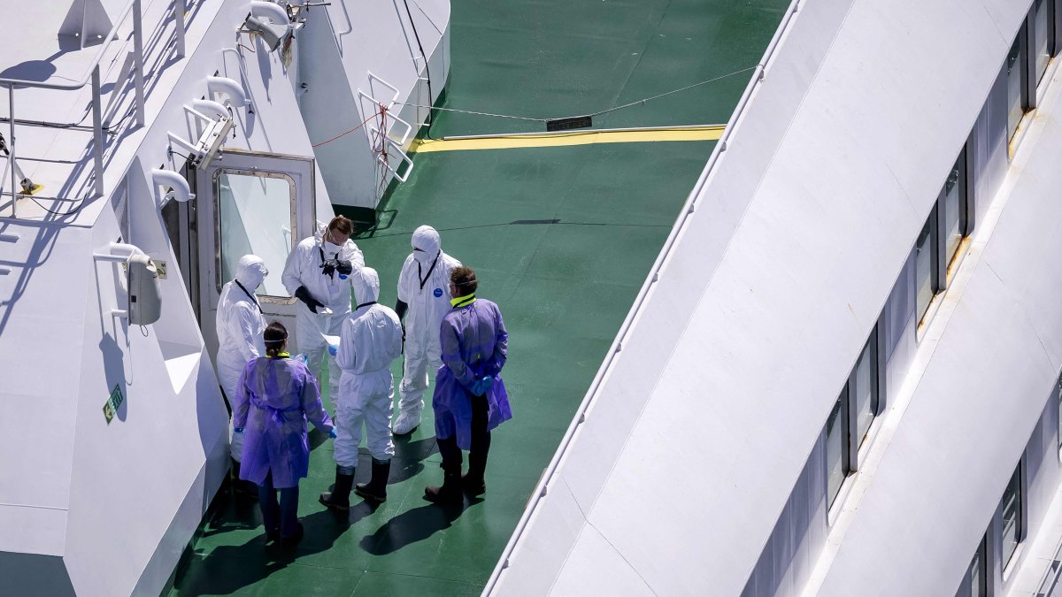 People wearing protective suits stand aboard the Dutch cruise ship MV Hondius after hantavirus outbreak, Rotterdam, Netherlands, May 18, 2026. (AFP Photo) 