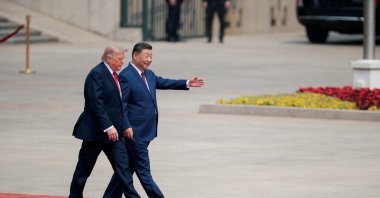 U.S. President Donald Trump walks with Chinese President Xi Jinping upon arrival at the Great Hall of the People in Beijing, China, May 14, 2026. (Reuters Photo)
