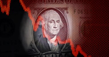 U.S. dollar banknote and decreasing stock graph are seen in this illustration taken April 25, 2025. (Reuters Photo)