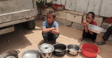 Palestinian children in camps wait in line for food aid, Gaza City, Palestine, May 18, 2026. (AA Photo)