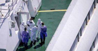 People wearing protective suits stand aboard the Dutch cruise ship MV Hondius after hantavirus outbreak, Rotterdam, Netherlands, May 18, 2026. (AFP Photo) 
