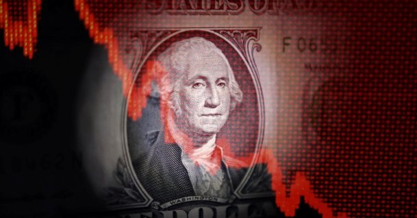 U.S. dollar banknote and decreasing stock graph are seen in this illustration taken April 25, 2025. (Reuters Photo)