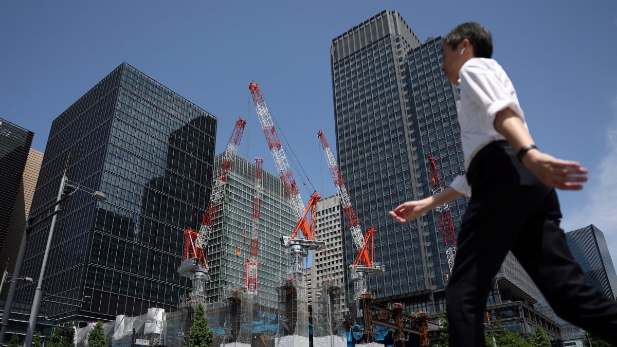 A man walks past a construction site in Tokyo, Japan, May 19, 2026. (Reuters Photo)