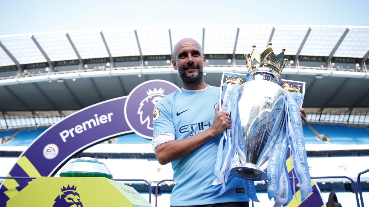 Manchester City manager Pep Guardiola celebrates with the trophy after winning the Premier League title after the match against Huddersfield Town at Etihad Stadium, Manchester, U.K., May 6, 2018. (Reuters Photo)
