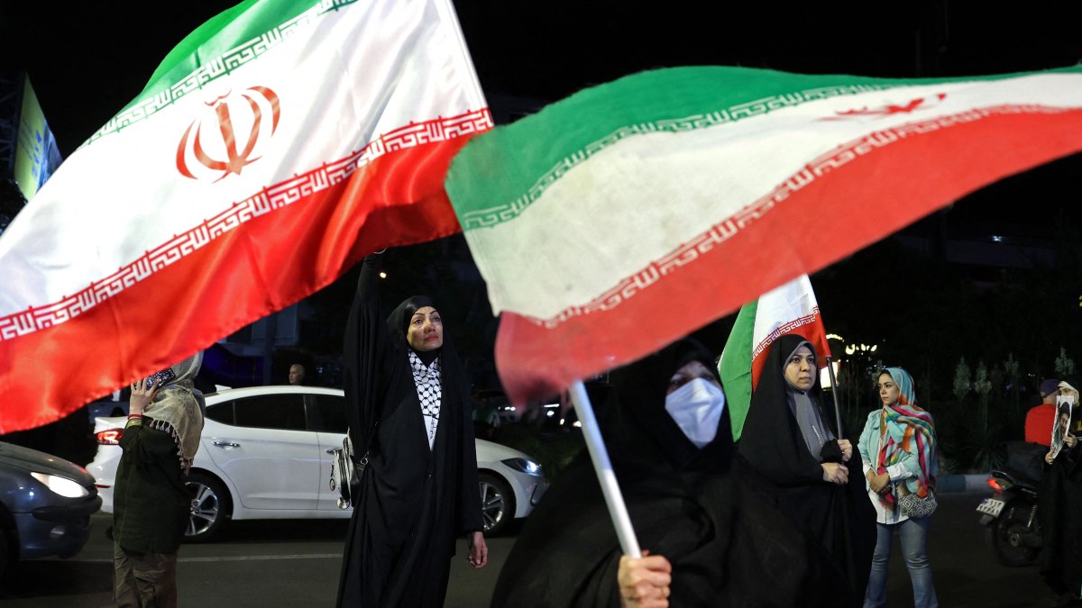 Women hold Iran's national flags during an anti-U.S. and Israel protest at Hafte Tir Square in Tehran, Iran, May 17, 2026. (AFP Photo)