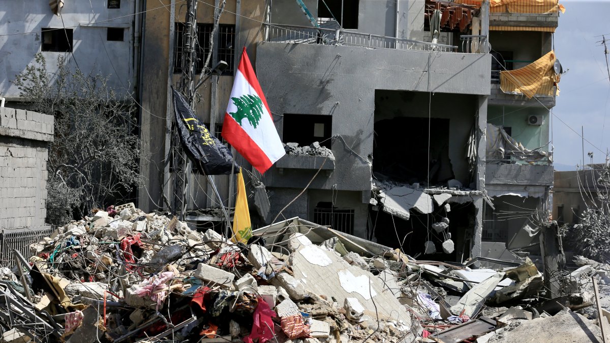 Lebanon's flag is seen planted on the debris of buildings destroyed by Israeli airstrikes in Zrariyeh, southern Lebanon, April 9, 2026. (DHA Photo)