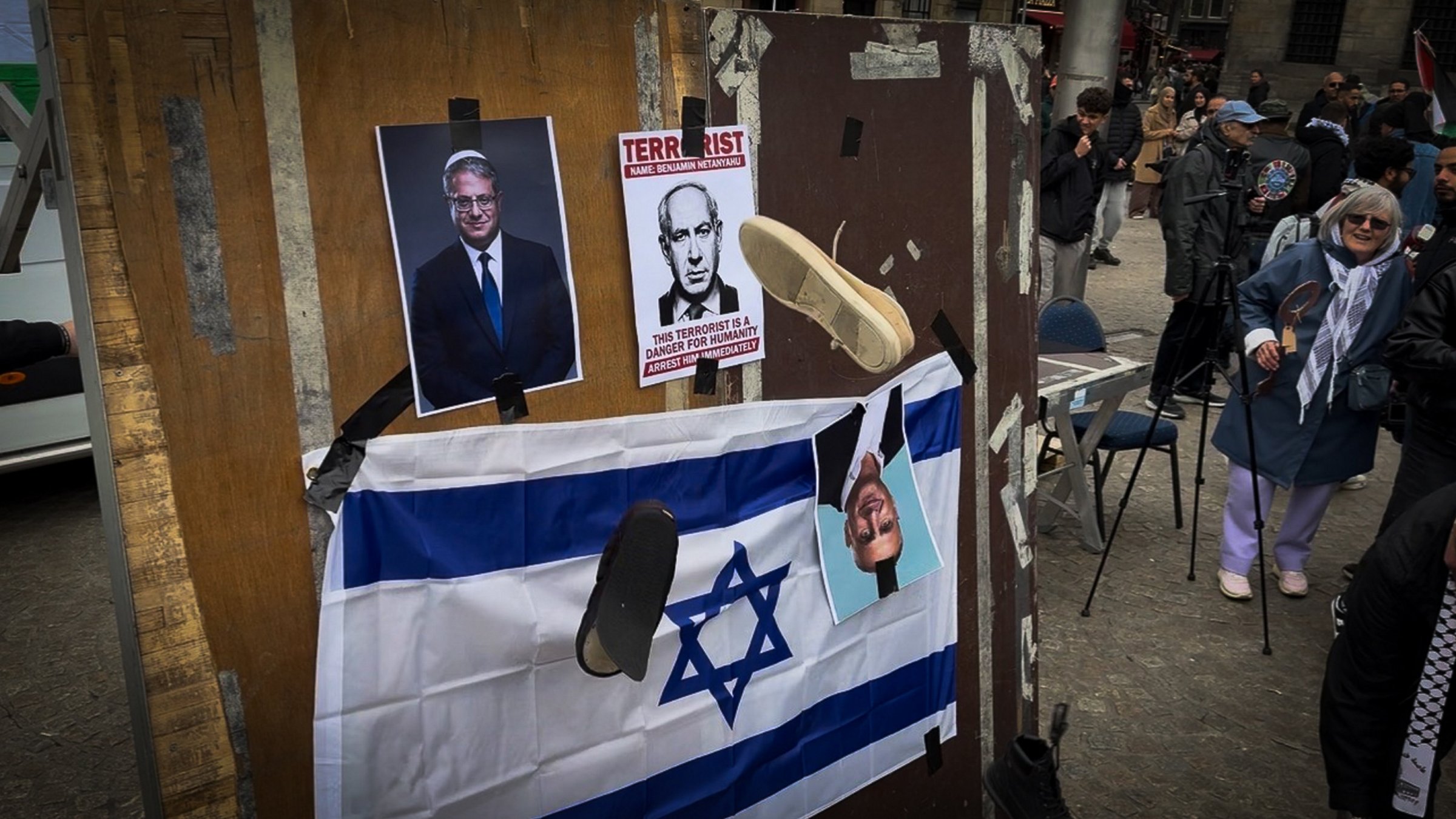 Protesters gather in a square where they display an Israeli flag alongside images of Israeli Prime Minister Benjamin Netanyahu and far-right minister Itamar Ben-Gvir, before throwing shoes at the flag and the photos in protest, Amsterdam, Netherlands, May 15, 2026. (AA Photo)