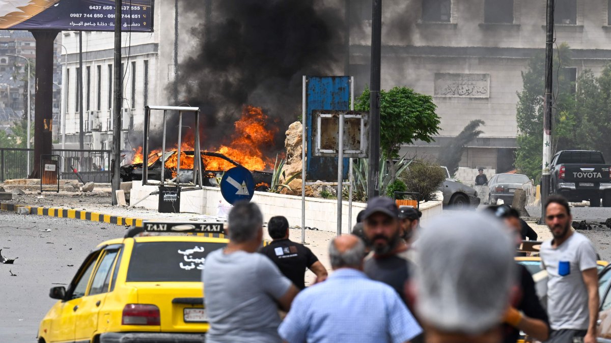 People watch a burning vehicle following an explosion in Damascus, Syria, May 19, 2026. (AFP Photo)