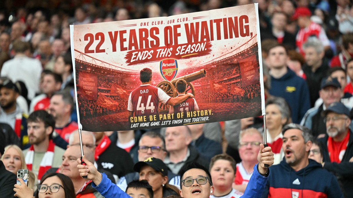 A hopeful Arsenal fan holds up a banner reading '22 years of waiting' ends this season, during the English Premier League football match between Arsenal and Burnley at the Emirates Stadium in London, Britain, May 18, 2026. (AFP Photo)