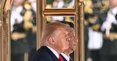 U.S. President Donald Trump (L) and Chinese President Xi Jinping stand for their countries' national anthems during a welcome ceremony at the Great Hall of the People, Beijing, China, May 14, 2026. (AFP Photo)