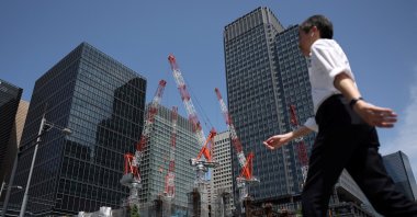 A man walks past a construction site in Tokyo, Japan, May 19, 2026. (Reuters Photo)