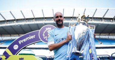 Manchester City manager Pep Guardiola celebrates with the trophy after winning the Premier League title after the match against Huddersfield Town at Etihad Stadium, Manchester, U.K., May 6, 2018. (Reuters Photo)