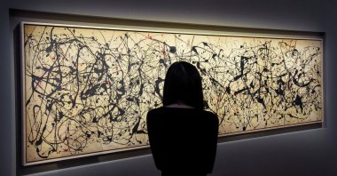 A person looks at the artwork titled "Number 7A," dated 1948 by Jackson Pollock, during the Christie's preview for the 20/21 Spring Marquee Week, New York City, U.S., May 8, 2026. (Reuters Photo)