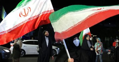 Women hold Iran's national flags during an anti-U.S. and Israel protest at Hafte Tir Square in Tehran, Iran, May 17, 2026. (AFP Photo)