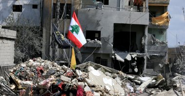 Lebanon's flag is seen planted on the debris of buildings destroyed by Israeli airstrikes in Zrariyeh, southern Lebanon, April 9, 2026. (DHA Photo)