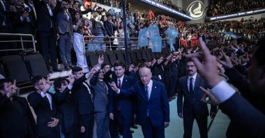 MHP leader Devlet Bahçeli makes wolf sign as he enters the venue for the event, Ankara, Türkiye, May 19, 2026. (AA Photo)