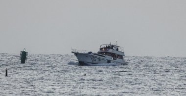 A boat bearing symbols of one of the vessels belonging to the Gaza-bound aid flotilla and attacked by the Israeli navy, is motored toward the Israeli port of Ashdod, May 19, 2026. (AFP Photo)