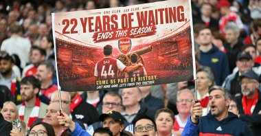 A hopeful Arsenal fan holds up a banner reading '22 years of waiting' ends this season, during the English Premier League football match between Arsenal and Burnley at the Emirates Stadium in London, Britain, May 18, 2026. (AFP Photo)