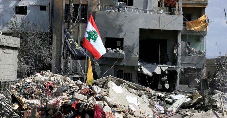 Lebanon's flag is seen planted on the debris of buildings destroyed by Israeli airstrikes in Zrariyeh, southern Lebanon, April 9, 2026. (DHA Photo)