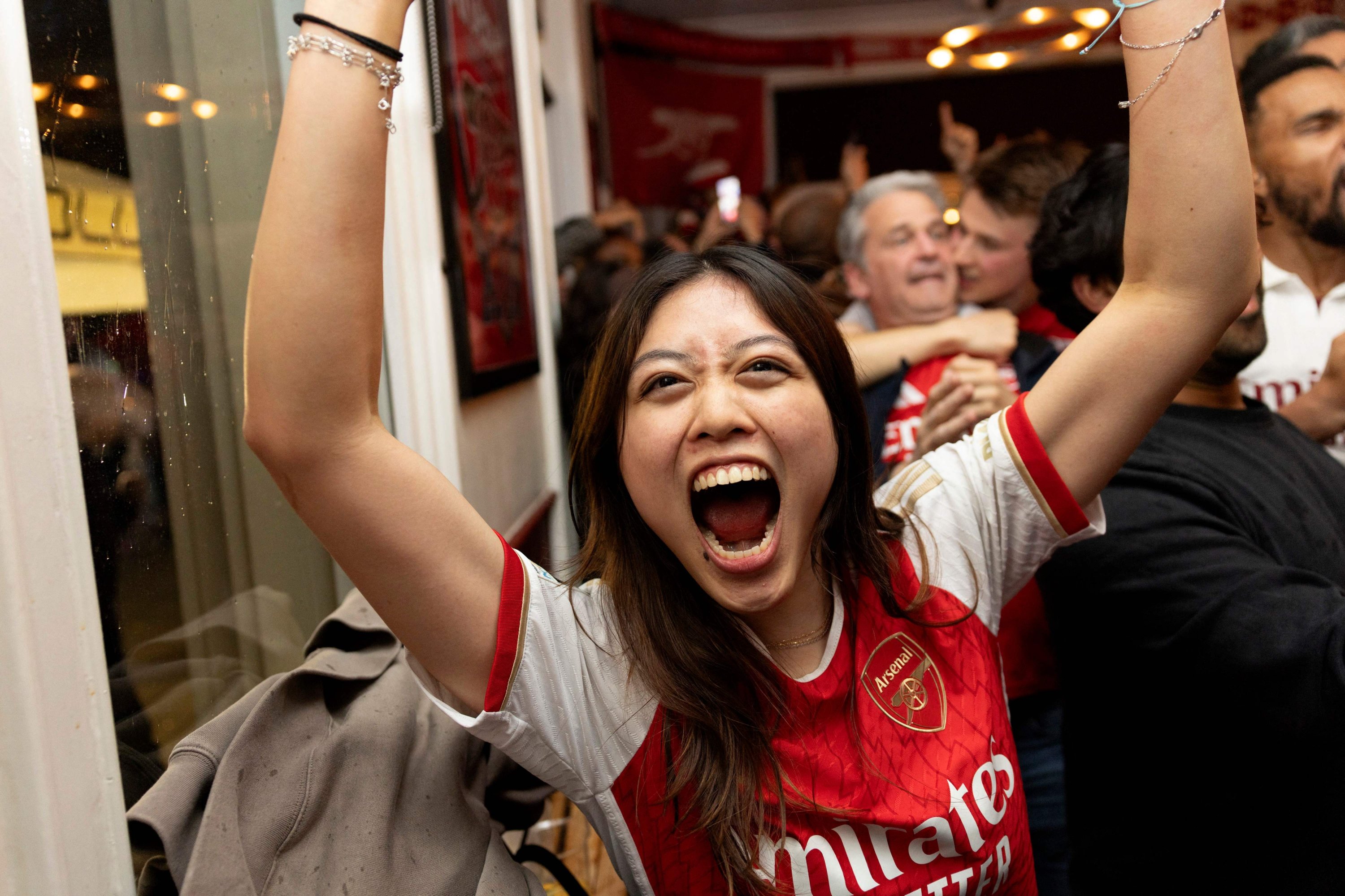 Arsenal fans celebrate their team winning the English Premier League, from inside the Tollington Arms pub near the Emirates Stadium,  London, U.K., May 19, 2026. (AFP Photo)