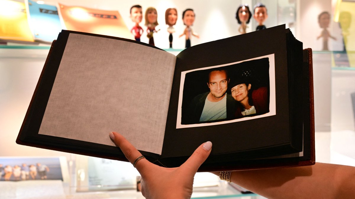 A photo album given by U.S. actor Jennifer Aniston to fellow "Friends" cast members Matthew Perry and Courtney Cox is displayed ahead of "The Matthew Perry Estate Auction" at Heritage Auctions in Beverly Hills, California, U.S., May 19, 2026. (AFP Photo)