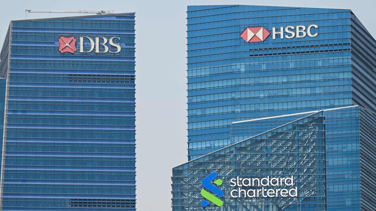 The logos of HSBC, DBS and Standard Chartered are seen on buildings in the Marina Bay financial centre in Singapore on May 5, 2026. (AFP Photo)