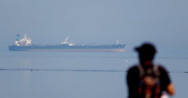 A tourist watches the MT Desert Kite oil tanker carrying Russian oil at Narara Marine National Park in the Arabian Sea, Gujarat, India, March 11, 2026. (Reuters Photo)