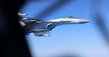 A handout picture released by Britain's Ministry of Defence (MOD) in London on May 20, 2026 shows Image of a Russian Su-35, seen here alongside an RAF Rivet Joint aircraft over the Black Sea in April 2026. (AFP Photo)