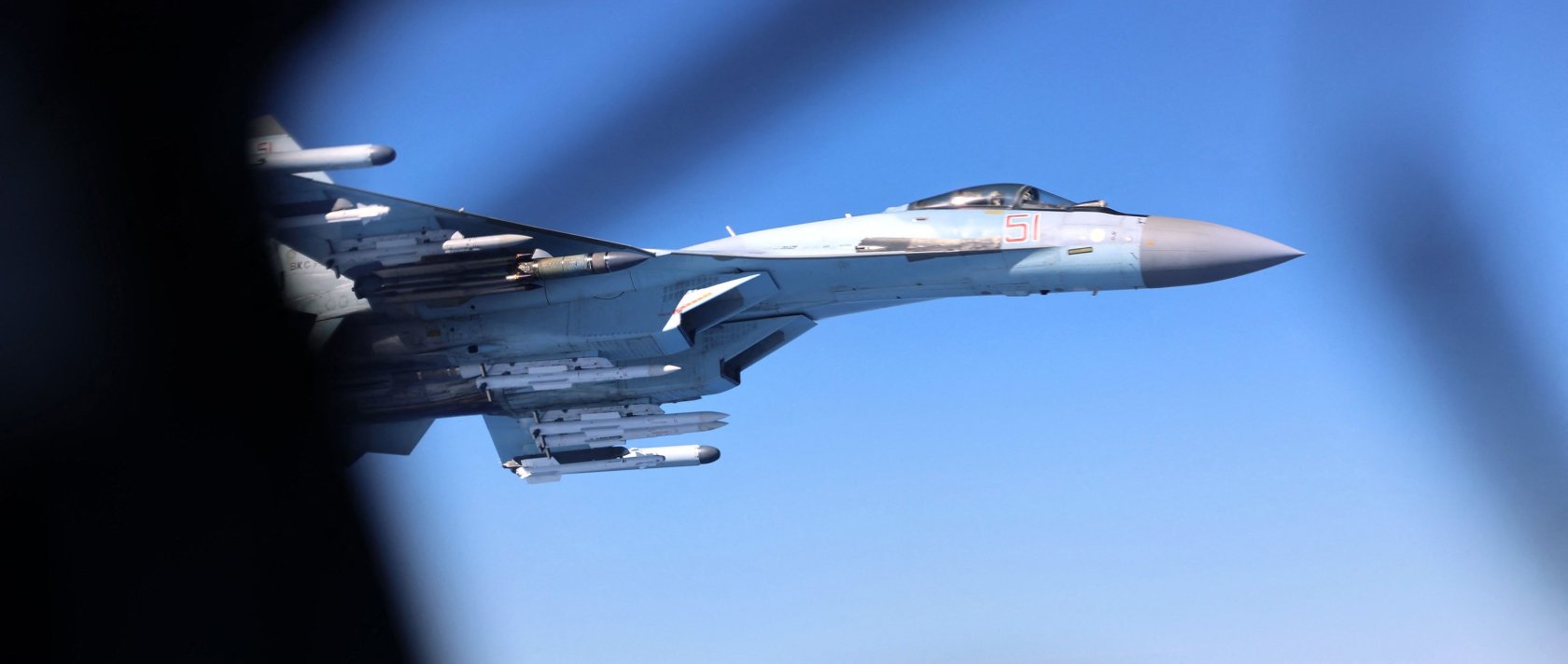A handout picture released by Britain's Ministry of Defence (MOD) in London on May 20, 2026 shows Image of a Russian Su-35, seen here alongside an RAF Rivet Joint aircraft over the Black Sea in April 2026. (AFP Photo)