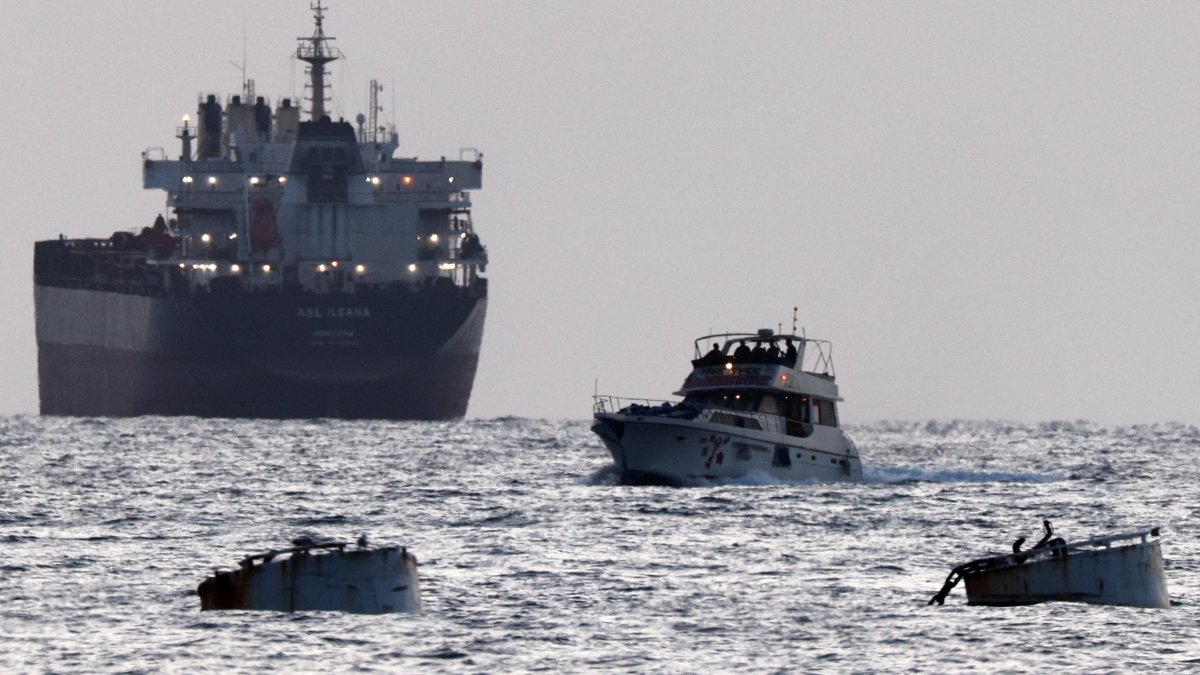 Israeli soldiers are seen on a vessel bearing symbols of the Global Sumud Flotilla, with a cargo ship behind it, as seen from Ashdod, southern Israel, May 19, 2026. (Reuters Photo) 