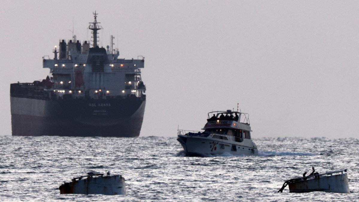 Israeli soldiers are seen on a vessel bearing symbols of the Global Sumud Flotilla, with a cargo ship behind it, as seen from Ashdod, southern Israel, May 19, 2026. (Reuters Photo)