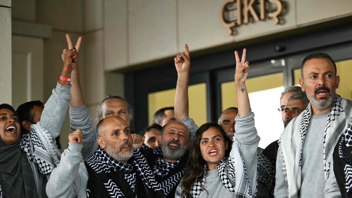 Members of the Global Sumud Flotilla, headed for Gaza and arrested and deported by Israel, pose outside a terminal following their arrival at Istanbul Airport on May 21, 2026. (AFP Photo)
