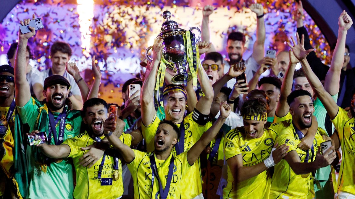 Al-Nassr's Cristiano Ronaldo and team members celebrate with the trophy after winning the Saudi Pro League, Riyadh, Saudi Arabia, May 21, 2026. (Reuters Photo)