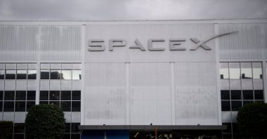 A pedestrian walks past the Space Exploration Technologies Corp. (SpaceX) former headquarters in Hawthorne, California, U.S., Jan. 28, 2021. (AFP Photo)