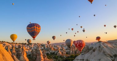 In an undated photo, colorful hot air balloons soar over Cappadocia, Nevşehir, central Türkiye. (Shutterstock Photo)