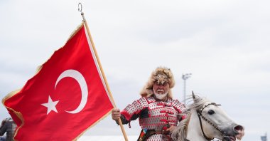 A traditional horseback rider waves the Turkish flag during the first day of the 8th Ethnosport Culture Festival, Istanbul, Türkiye, May 21, 2026. (AA Photo)