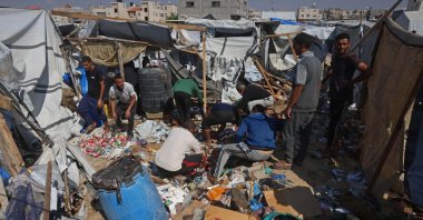 Displaced Palestinians inspect the site of an Israeli strike that targeted a food distribution tent in the Mawasi area of Khan Younis, in the southern Gaza Strip, May 21, 2026. (AFP Photo)