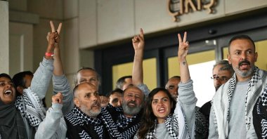 Members of the Global Sumud Flotilla, headed for Gaza and arrested and deported by Israel, pose outside a terminal following their arrival at Istanbul Airport on May 21, 2026. (AFP Photo)