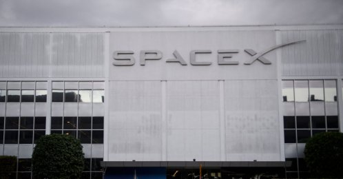 A pedestrian walks past the Space Exploration Technologies Corp. (SpaceX) former headquarters in Hawthorne, California, U.S., Jan. 28, 2021. (AFP Photo)