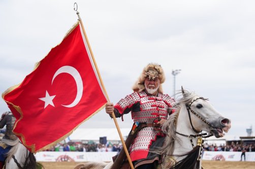A traditional horseback rider waves the Turkish flag during the first day of the 8th Ethnosport Culture Festival, Istanbul, Türkiye, May 21, 2026. (AA Photo)