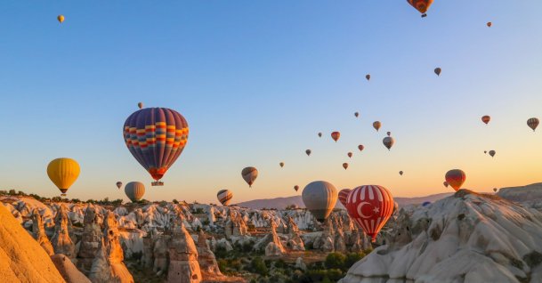 In an undated photo, colorful hot air balloons soar over Cappadocia, Nevşehir, central Türkiye. (Shutterstock Photo)