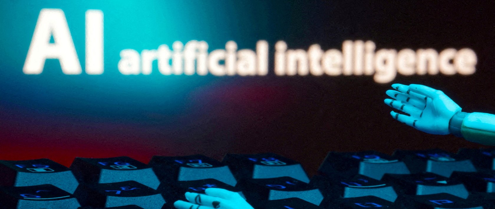 A message reading "AI artificial intelligence," a keyboard and robot hands are seen in this illustration created on Jan. 27, 2025. (Reuters File Photo)